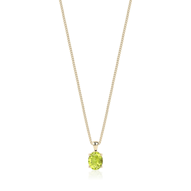 Oval concave cut peridot pendant set in 14 karat