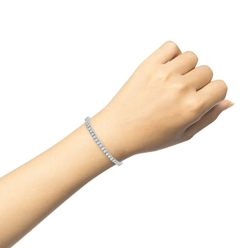 Diamond tennis bracelet in 18k white gold with four prong setting on wrist
