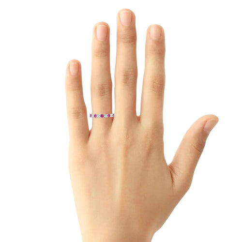 Shared prong diamond and pink sapphire wedding band in 14 k on hand
