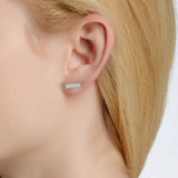 Diamond bar earring on ear