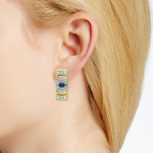 Diamond and sapphire earrings in 18 k gold on ear