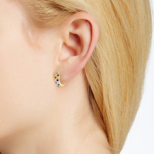 Diamond and sapphire "huggy" style earrings in 18k yellow gold on ear