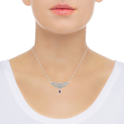 Diamond and sapphire pendant necklace on neck