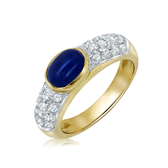 Bezel set oval cabochon sapphire and diamond ring in 18k gold
