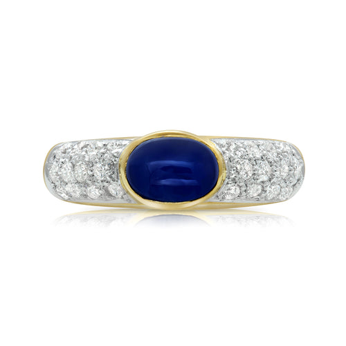 Bezel set oval cabochon sapphire and diamond ring in 18k gold